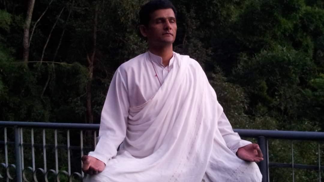 Guru Puskar Raj Pant seated in meditation